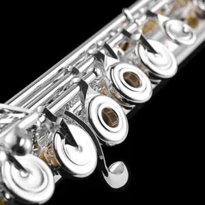 Close up of intermediate silver flute with offset g keys and open holes and C# lever.
