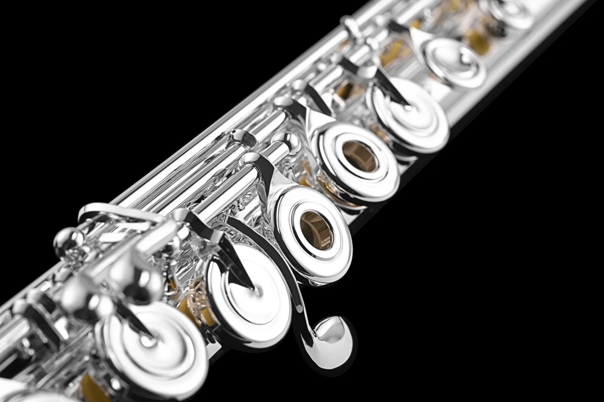 Close up of intermediate silver flute with offset g keys and open holes and C# lever.