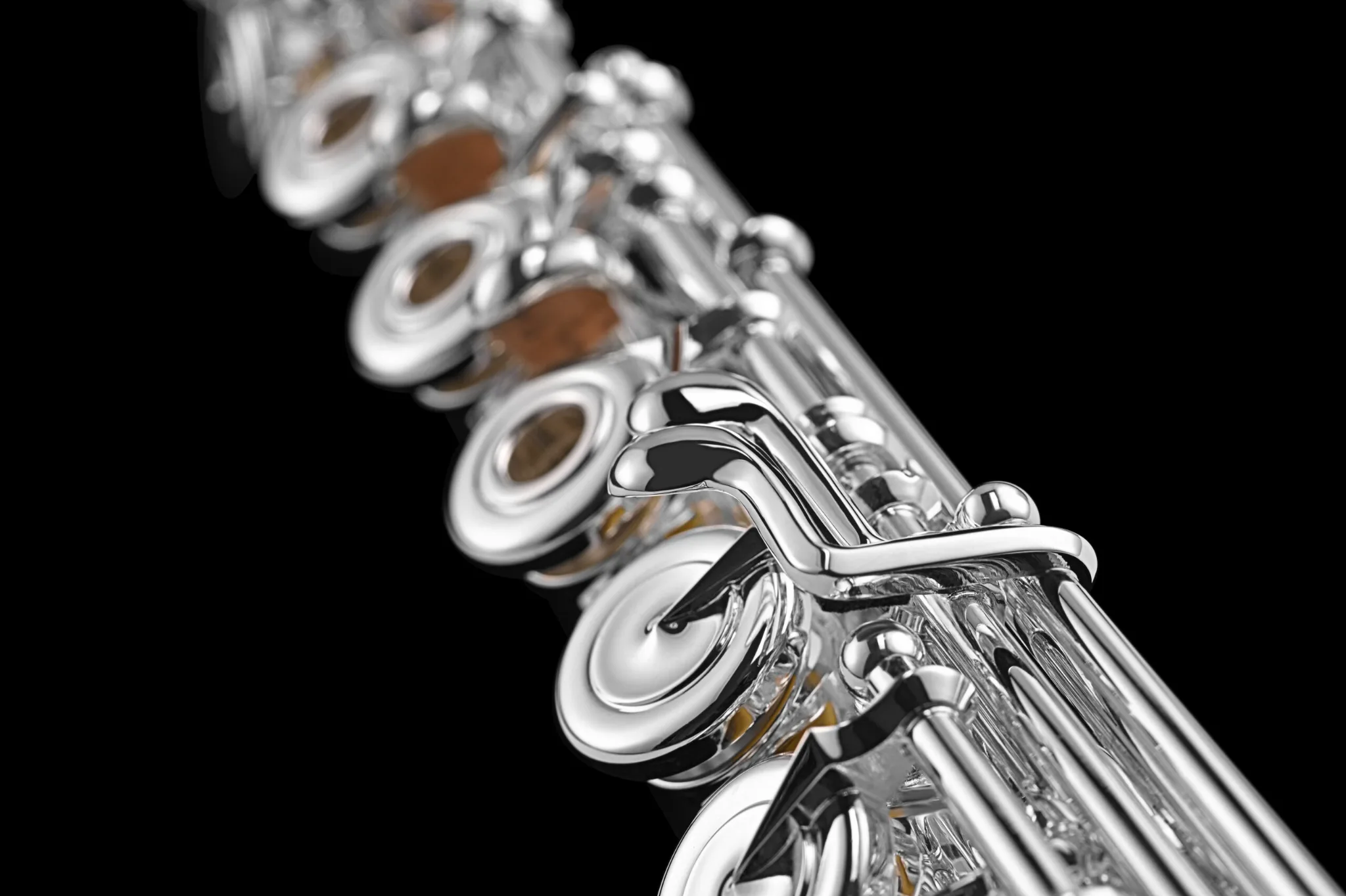 Close up of silver intermediate level flute lever keys for C# trill and open hole flute.